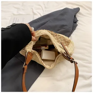 Detail view of large straw beach bag interior showing spacious capacity and zipper closure