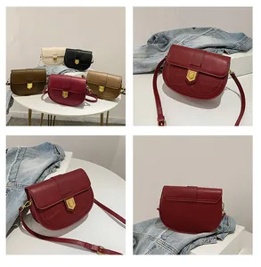 Detail view of retro saddle bags with crocodile texture and golden metal buckle accents