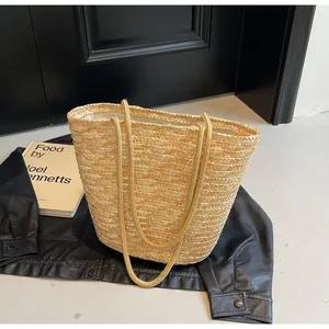 Close-up of hand-woven straw tote bag with fine texture and fabric lining for summer beach