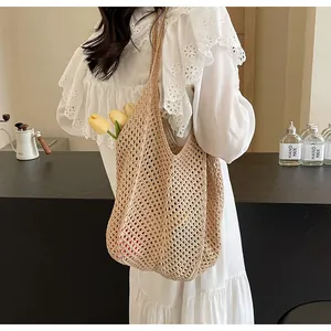 Detail view of beige hand-woven crochet tote bag featuring hollow knit mesh and cotton rope