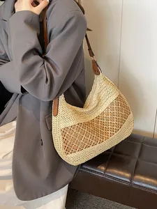 Beige woven straw hobo bag with diamond hollow patterns and brown shoulder strap