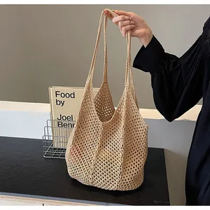 Detail of beige hollow woven tote bag showing delicate crochet texture and integrated strap