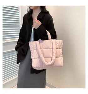 Detailed view of pink padded puffer tote bag with quilted pattern and large capacity
