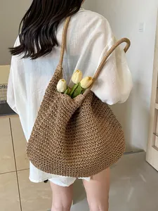 Large dark brown straw tote bag for women showing a spacious handmade beach shoulder design