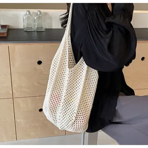 Detail of white crochet tote bag showing woven texture and spacious interior capacity