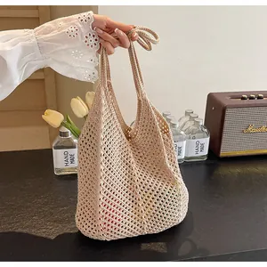 Detailed close-up of a beige crochet tote bag showing hollow-out texture and large capacity