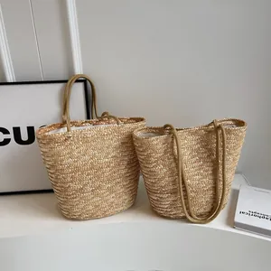 Macro detail of hand-woven straw tote bag with fabric lining and dual straps