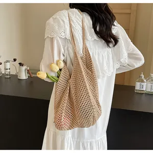 Detail of hand-woven beige tote bag with hollow mesh design used for casual lifestyle