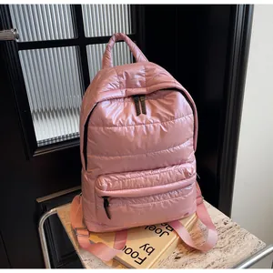 Close-up of pink quilted backpack showing horizontal stitching and durable nylon texture