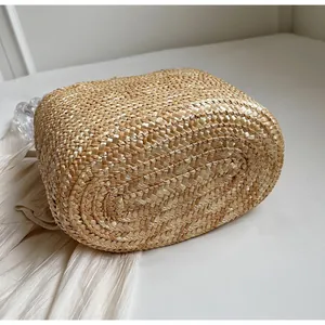 Detailed close-up of natural straw weave texture on large capacity beach tote bag