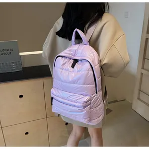 Close-up of light purple quilted backpack showing waterproof nylon fabric and zippers