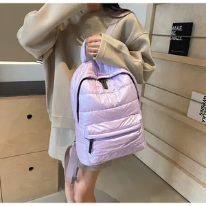 Close-up of quilted puffer backpack in lavender purple with front zipper detail