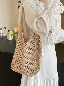 Chic hollow-out woven tote bag for women shown with elegant summer dress in a cafe