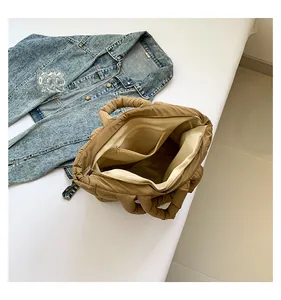 Interior view of khaki quilted puffer tote showing spacious compartment and zipper pocket