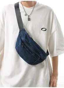 Detailed view of dark blue washed denim crossbody bag with adjustable nylon straps