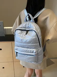 Casual light blue quilted puffer backpack for women with spacious pockets and glossy finish