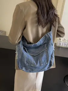 Blue denim crossbody tote bag with ripped fringe detailing and large capacity for women