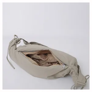 Detailed interior view of khaki pleated croissant bag showing spacious main compartment