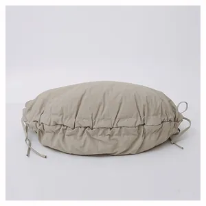 Detail view of khaki pleated shoulder bag showing soft nylon texture and drawstring