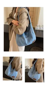Detail of vintage denim tote bag showing metal rivets, leather patch, and hobo style texture