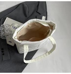 Dettaglio della borsa shopper trapuntata bianca con cerniera e fodera interna beige spaziosa