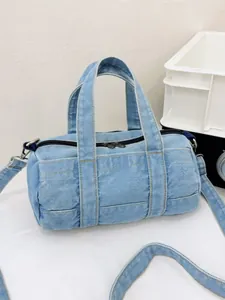 Light blue denim barrel handbag with dual handles and adjustable shoulder strap for casual wear