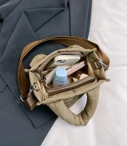Detailed interior of khaki quilted crossbody bag showing spacious storage compartments