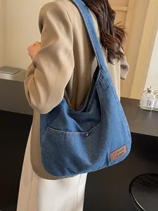 Large vintage denim hobo tote bag for women with functional side pockets and leather tag