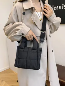 Quilted black puffer crossbody bag for women with wide nylon strap and sleek finish