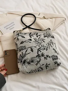 Retro canvas shoulder bag with black floral embroidery and woven strap in cream white