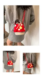 Detail of handmade crochet mushroom bucket bag with white dots and drawstring bow tie