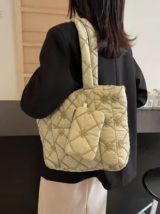 Quilted light green tote bag with floral embroidery and matching small pouch