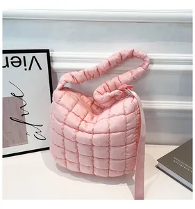 Detail view of the pink quilted cloud bag showing soft puffer texture and square stitching