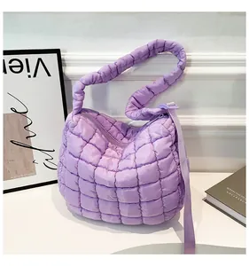 Close-up of lavender quilted puffer bag with soft texture and matching shoulder strap