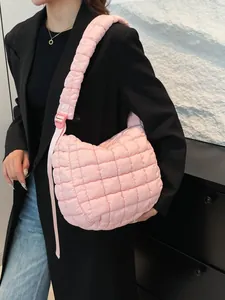 Chic pink quilted cloud bag with padded shoulder strap shown on fashion model