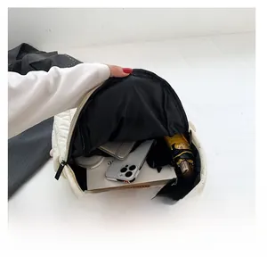 Internal view of cream quilted nylon backpack showing large storage space for daily items