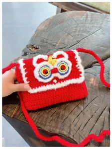 Detailed view of handmade red crochet lion dance bag with woven texture and pearl buckle