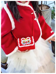 Detail showing handcrafted red crochet lion dance crossbody bag with textured knitting for kids