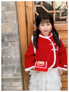 Detail of red Chinese New Year knit bag with lion dance embroidery on a child outfit
