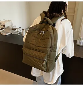 Detail of olive green quilted backpack with soft padded straps and nylon finish