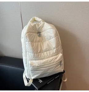 Detailed view of the off-white quilted puffer backpack with silver metal zippers