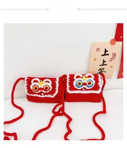 Detail of handmade crochet lion dance mini bags with red yarn and festive charms