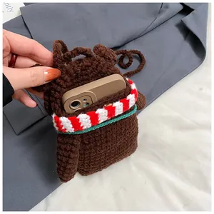 Close-up of handmade crochet bear bag showing knitted texture and phone storage capacity