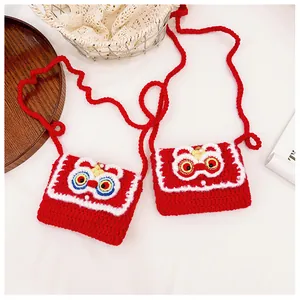 Detail of handmade crochet lion dance bags for kids with festive red yarn and pearl accents