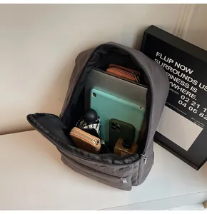 Internal view of large capacity quilted gray backpack with laptop and accessories