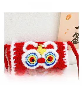 Macro detail of handmade crochet lion dance mini bag with red wool and pearl clasp
