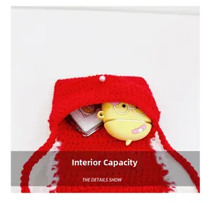 Internal capacity of mini red crocheted bag showing small items and pearl button detail