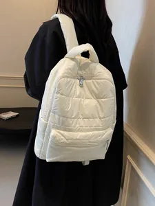 Minimalist beige quilted puffer backpack with large capacity for winter travel and commuting