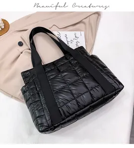 Chic black quilted puffer tote bag with glossy nylon finish and square padding