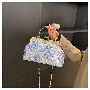 Detail of vintage Chinese embroidery bag with dragon patterns and gold metal clasp